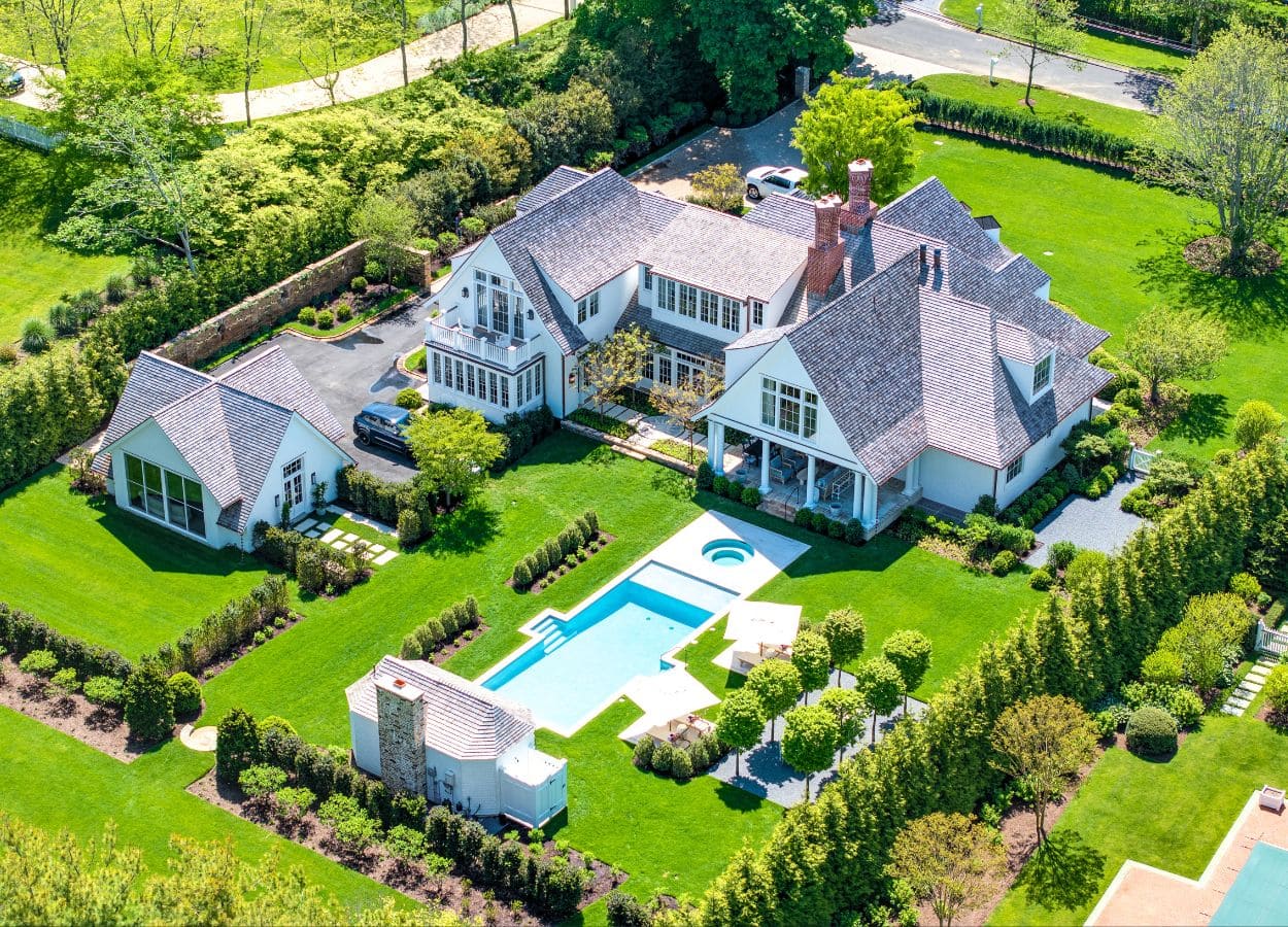 aerial view of a luxury East Hampton house with a pool and pool cabana