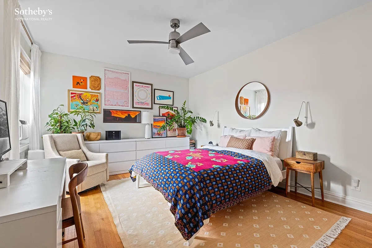 bedroom with wood floor, white walls, ceiling fan