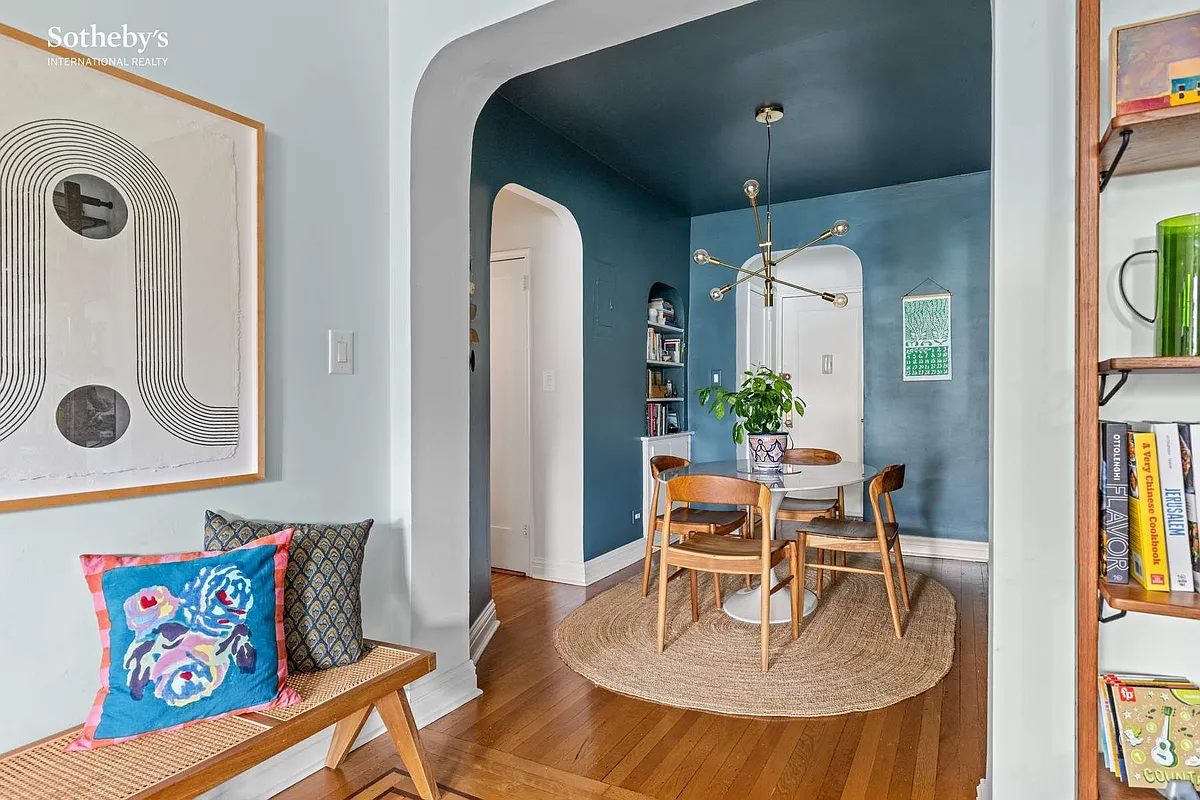 entry foyer with blue walls, room for a small dining table