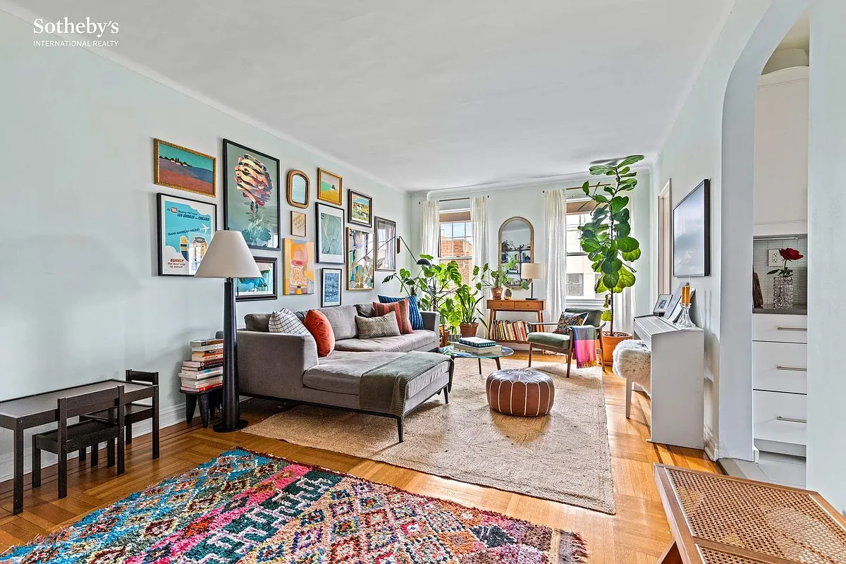 living room with wood floor, arched doorway